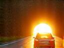 Car entering sunlit Austrian tunnel during summer drive