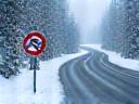Snow-dusted Austrian mountain road, winter tires and chains required